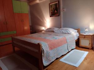 a bedroom with a bed and a dresser in it at Apartments Lazzarini Battiala in Nedeščina