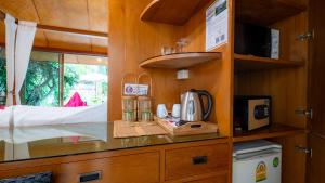 a kitchen with a counter with a coffee maker at Pattaya Bungalow II, Totally Private Pool in Pattaya South