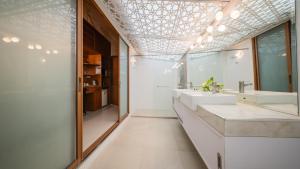 a bathroom with two sinks and a large mirror at Pattaya Bungalow II, Totally Private Pool in Pattaya South +22 photos