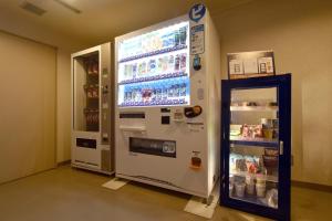 a vending machine with a drink cooler next to it at Hotel Sapporo Sun Plaza in Sapporo