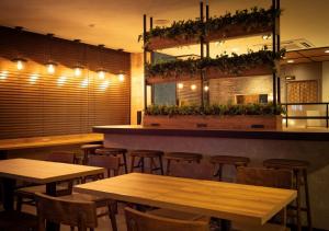 a bar with wooden tables and chairs in a restaurant at Super Hotel Minami Hikone Ekimae in Hikone