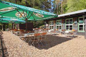 a group of tables and chairs in front of a building at Hotel & Restaurant Rhönhäuschen in Bischofsheim an der Rhön