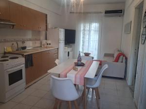 a kitchen with a table and chairs in a kitchen at NiRa house in Pefkochori