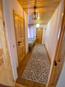 a hallway with a door and a bed in a room at Sarala Resort in Ostrov Kayrak