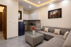 a living room with a couch and a table at The Ushmaya Lifestyle Wellness Resort Near Rishikesh in Haridwār