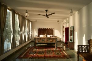 a living room with a table and a ceiling fan at Paddy's Loft The Lake B&B in Udaipur