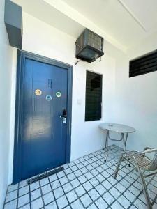 a blue door in a room with a table at Moalboal Seaside Resort in Moalboal