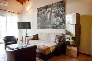 a living room with a couch and a table at Μεζονέτα AIKATERINI N 17 in Chios