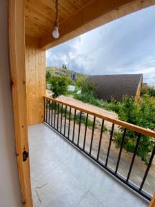 a balcony with a view of a house at Sarala Resort in Ostrov Kayrak +4 photos