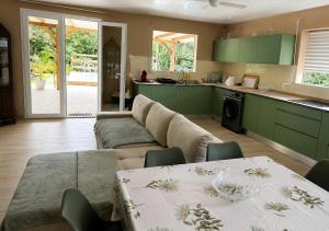 a living room with a couch and a table at Évasion Caraïbes in Ducos