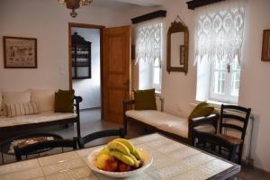a living room with a bowl of fruit on a table at Avli in Samothraki