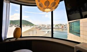 a large window with a view of the water at De Lamour Hotel in Tongyeong