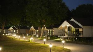 a row of houses lit up at night with lights at Evoke Rambagh Resort Ayodhya in Ayodhya