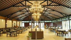 a large dining room with tables and a chandelier at Evoke Rambagh Resort Ayodhya in Ayodhya