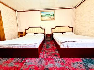 two beds sitting next to each other in a room at City Hostel & Tours in Ulaanbaatar +156 photos