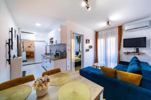 a living room with a blue couch and a table at Dream Apartment in Vrnjačka Banja