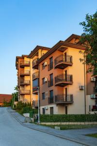 a building with balconies on the side of a street at Dream Apartment in Vrnjačka Banja