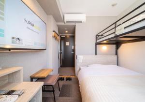 a hotel room with a bed and a flat screen tv at Super Hotel Premier Obihiro Ekimae in Obihiro +78 photos
