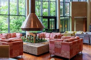 a lobby with couches and a large room with windows at Hyatt Regency Hakone Resort and Spa in Hakone