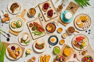 a table with many plates of food on it at Khao Lak Marriott Beach Resort & Spa in Khao Lak