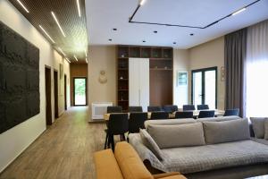 a waiting room with couches and chairs in a building at Aries Villa Albania in Vorë