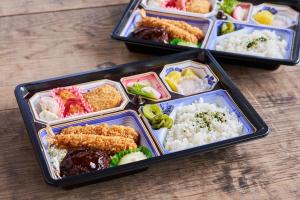 three containers of food on a table with rice at SEN HAVEN Sakurai in Shingū