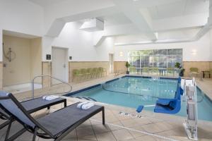 a large pool with chairs at Hampton Inn & Suites Berkshires-Lenox in Lenox