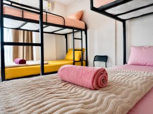 two bunk beds with a pink towel on the bed at Swift Hostel Limassol in Limassol