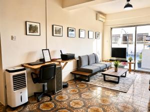 a living room with a couch and a television at Swift Hostel Limassol in Limassol +13 photos