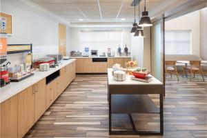 a large kitchen with a counter and a cafeteria at Hampton Inn & Suites Berkshires-Lenox in Lenox