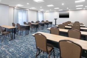 a large room with tables and chairs and a screen at Hampton Inn & Suites Berkshires-Lenox in Lenox +53 photos