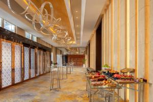 a lobby with tables with food on them at Hyatt Regency Riyadh Olaya in Riyadh
