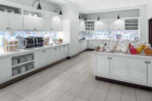a large kitchen with white cabinets and appliances at Hyatt Place Athens Downtown in Athens