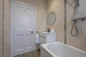 a bathroom with a white toilet and a mirror at Sandyhill, St. Andrews in Fife +21 photos