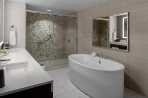 a white bathroom with a tub and a shower at Hyatt Place Athens Downtown in Athens +31 photos