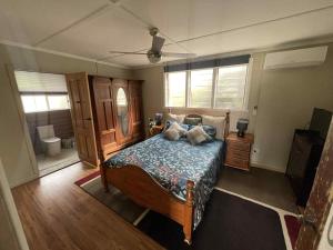a bedroom with a bed and a ceiling fan at Jack's Tidal Pool Shack in Kingscote