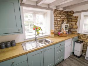 a kitchen with a sink and a counter at The Cottage in Stratford-upon-Avon