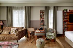 a living room with a couch and a chair at Skald Hotel Akureyri, Curio Collection By Hilton in Akureyri