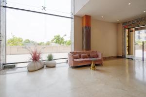 a living room with a couch and a large window at Palette Mahbubabad Railway Station Formerly Hotel RC Platinum in Mahbūbābād +67 photos