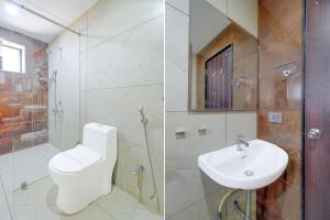 a bathroom with a toilet and a sink and a shower at Palette Mahbubabad Railway Station Formerly Hotel RC Platinum in Mahbūbābād