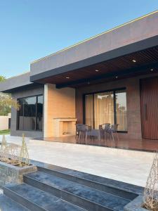 a building with a table and chairs in front of it at SA Farms in Lahore