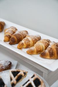 a bunch of pastries on plates on a table at Hotel Diadema in Diamante