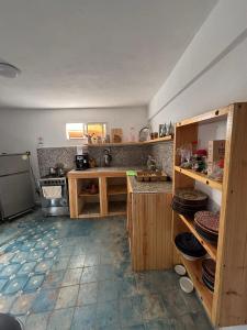 a kitchen with wooden cabinets and a counter top at Jara Cimrmann surf house in Imsouane +9 photos