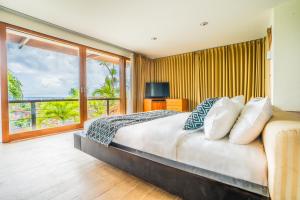 a bedroom with a bed with a view of the ocean at Hening Jimbaran in Jimbaran +77 photos