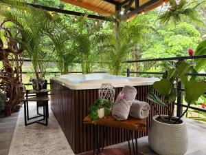 a bath tub in a garden with plants at Arenal Rain Forest Lodge in Fortuna