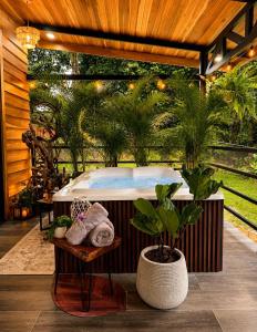 a hot tub in a room with plants in it at Arenal Rain Forest Lodge in Fortuna