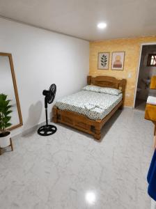 a bedroom with a bed and a fan in it at ECOHOTEL LILI in Puerto Limón +7 photos