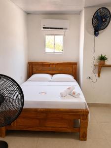 a bedroom with a bed with two towels on it at ECOHOTEL LILI in Puerto Limón