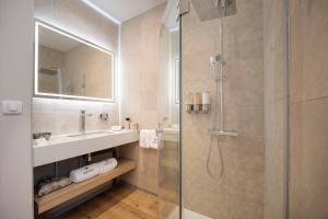 a bathroom with a shower and a sink and a mirror at APATOA Beach & Garden Village in Raiatea +44 photos