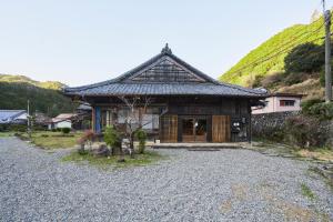 a house with a roof on a gravel driveway at SEN HAVEN Nakamura in Shingū